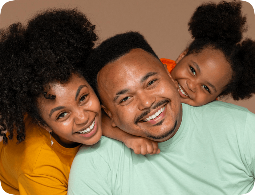 An image of a man and his two daughters smiling